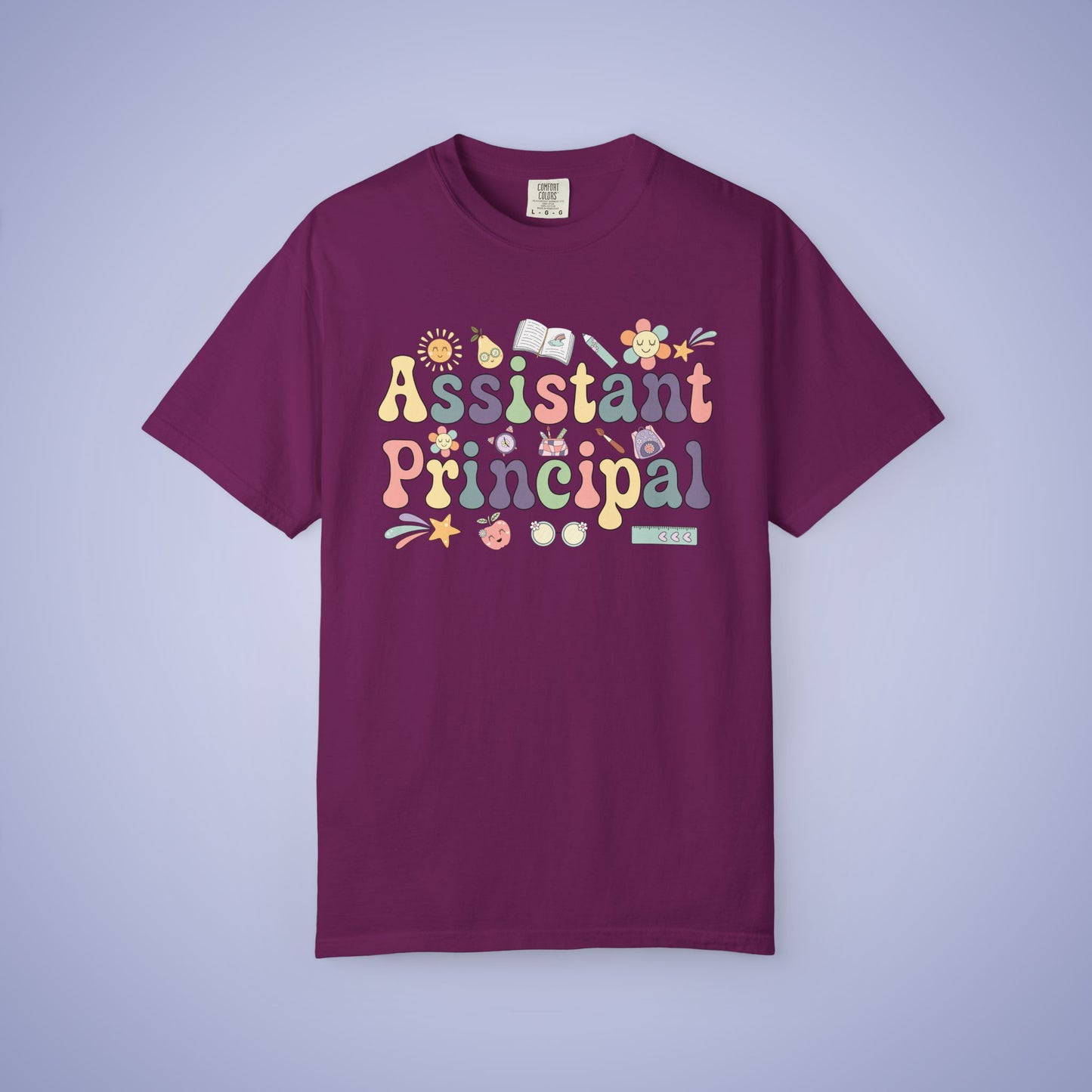 Maroon t shirt with 'Assistant Principal' text and decorative elements on a light purple background