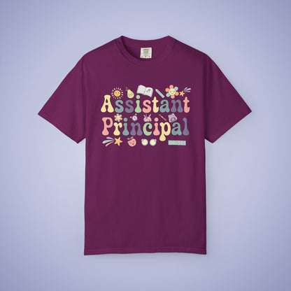Maroon t shirt with 'Assistant Principal' text and decorative elements on a light purple background
