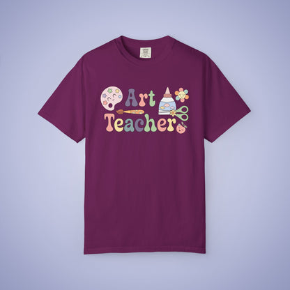 Maroon t shirt with 'Art Teacher' text and graphics on a boysenberry purple background