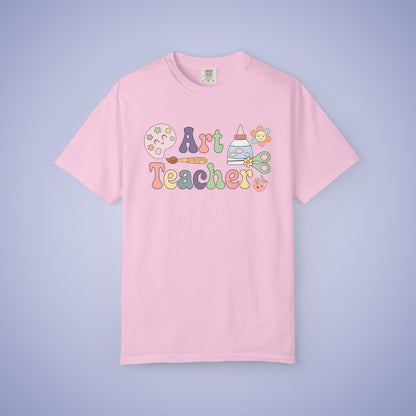 Pink t shirt with 'Art Teacher' text and graphics on a light pink background