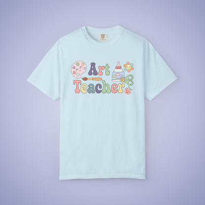 Light blue t shirt with 'Art Teacher' text and graphics on a blue background
