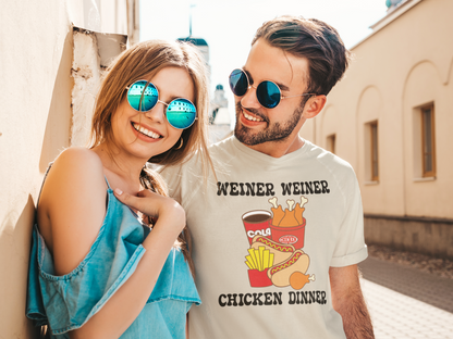 A smiling couple outdoors wearing round sunglasses. The woman wears blue mirrored sunglasses and a light blue top, while the man wears round blue mirrored sunglasses and a white graphic t-shirt that reads 'WEINER WEINER CHICKEN DINNER' with a KFC and hot dog illustration.